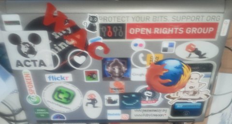 Laptop covered in stickers.