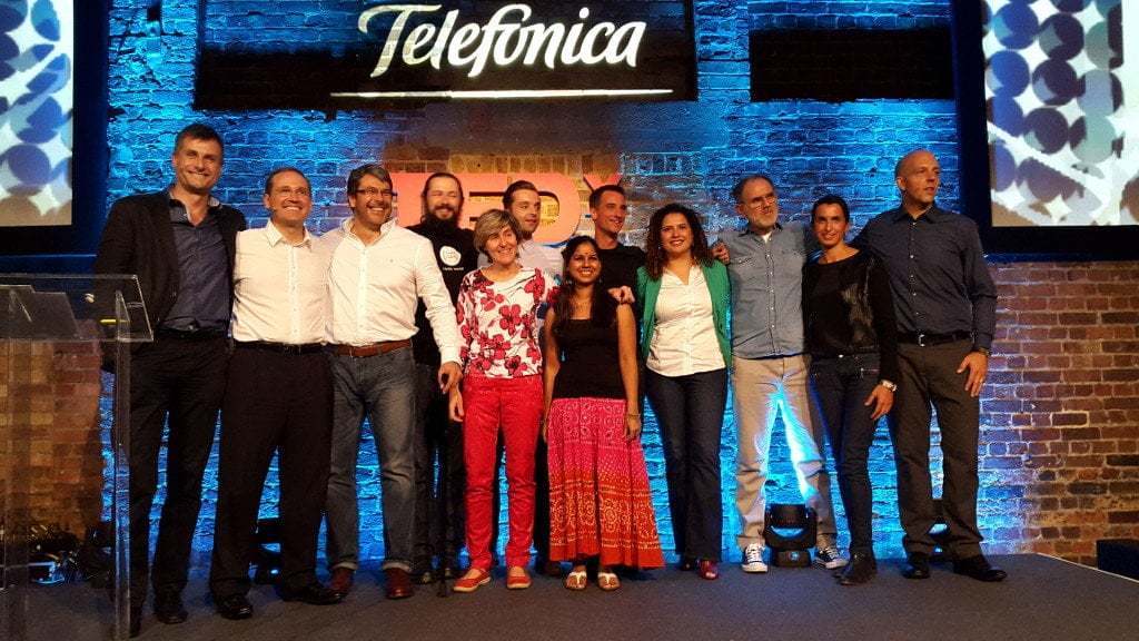 Photo of speakers at a TedX talk.