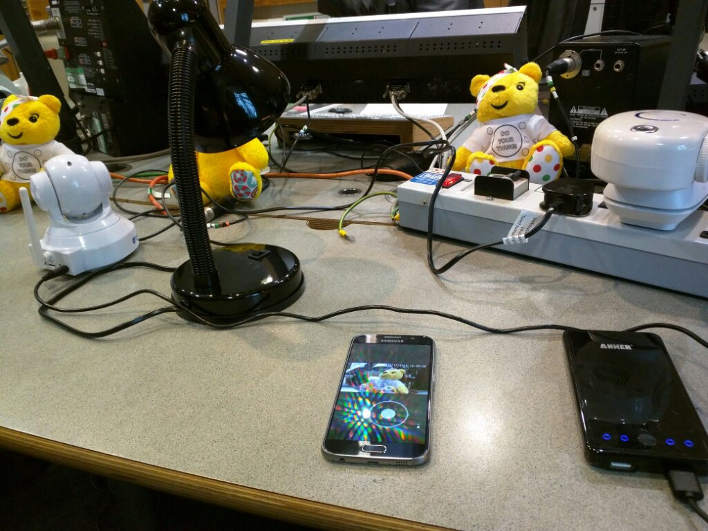 A bunch of smartphone equipment on a radio broadcast desk.