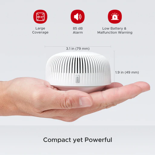 A small smoke alarm in the palm of someone's hand.