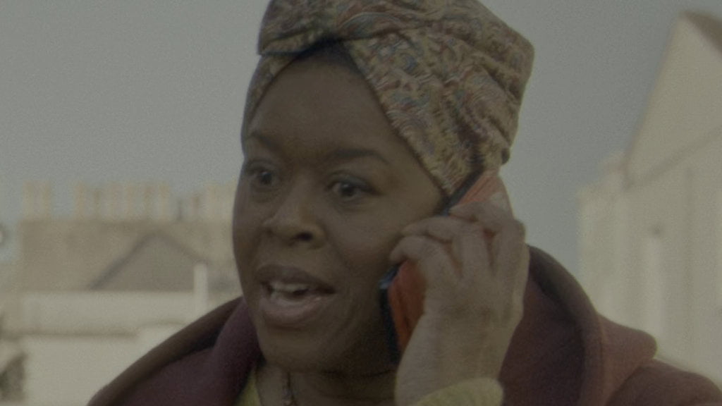 Carla holding a phone.