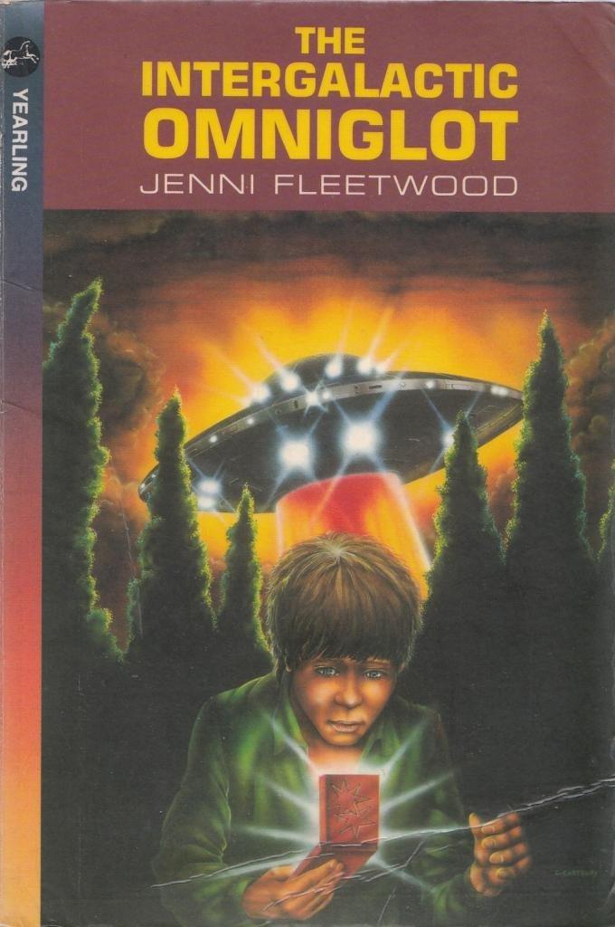 Paperback book cover. A UFO rises behind a young man. The Boy is holding what looks like a foldable Gameboy.